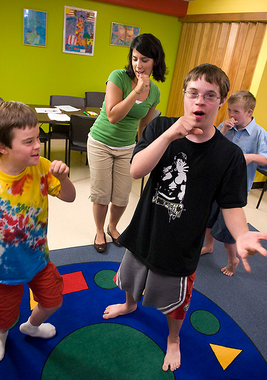 Three children with Down syndrome sing along with a speech-language 