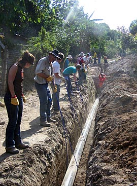 Photo of people working on wastewater system