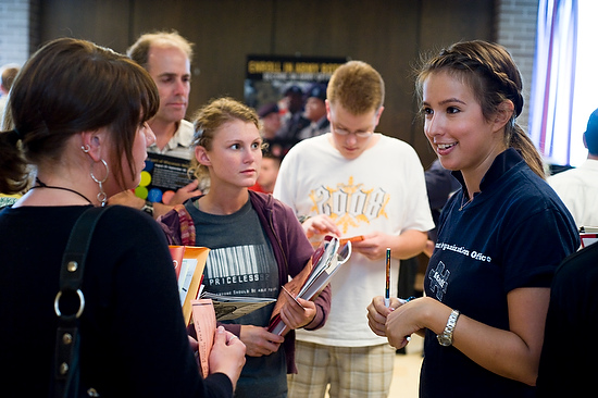Photo of students and parents talking with staff