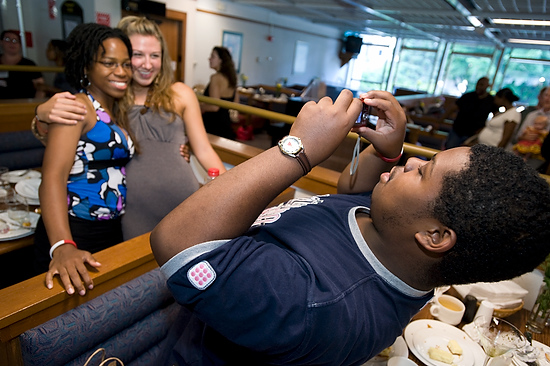 A student housefellow  photographs two friends, also housefellows.