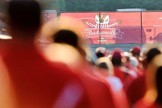 Photo showing Badger fans and Badgerville banner.