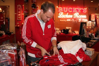 Photo of Matt Kellerman unpacking boxes of Badger apparel.