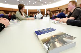 Photo of students discussing &rdquo;Enrique&rsquo;s Journey&rdquo;.