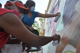 Photo: people painting a mural