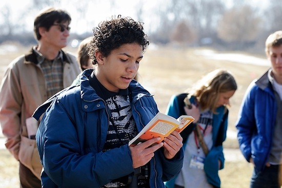 Photo: middle school student reading from "A Sand County Almanac"