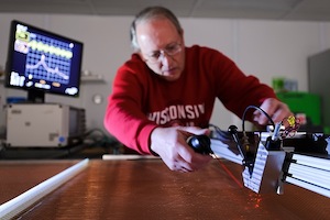Photo: Dan Wahl operating laser