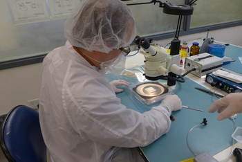 Photo: Technician examining laser components