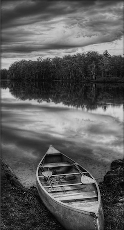 Photo: Quiet lake with boats and trees