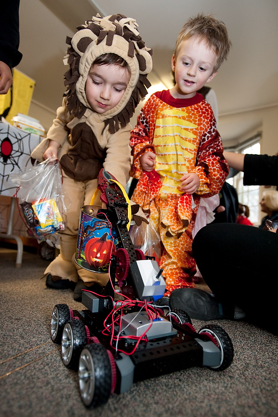 Photo of two kids dressed up in Halloween costumes having fun at the Human Development and Family Studies building.