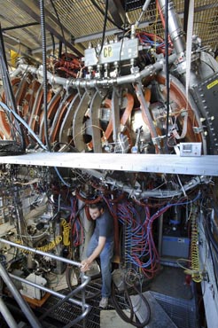 Photo of a man surrounded by electrical equipment.