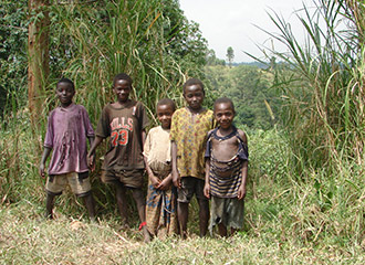 Photo: Children of Uganda, wearing torn clothing.