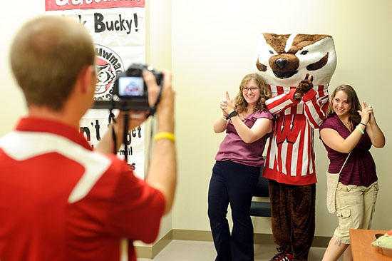 Photo of two students posing for a photo with Bucky Badger.