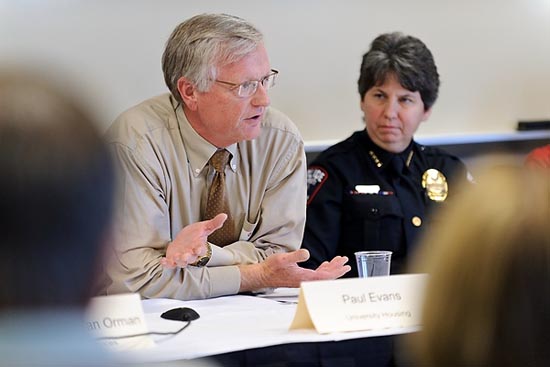 Photo of housing director Paul Evans sitting with Police Chief Sue Riseling.