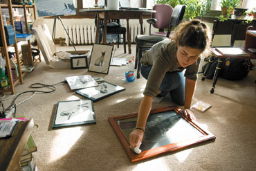 Photo of Michelle Bridwell cleaning her artwork