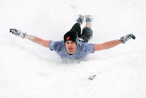 Photo of student sliding down Observatory Hill