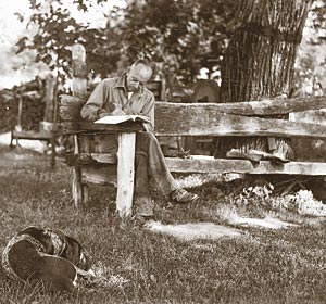 Aldo Leopold writing at the famous Shack with his dog Flick, 1940.