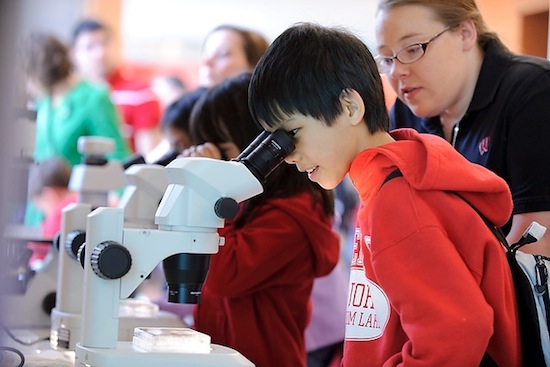 Photo: child looking into microscope