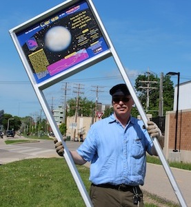Photo: man installing sign