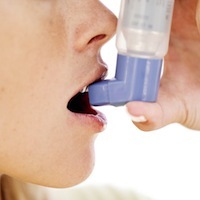 Photo: person using inhaler
