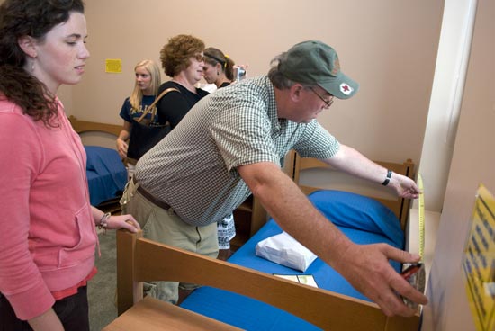 Student and parents in a residence hall room