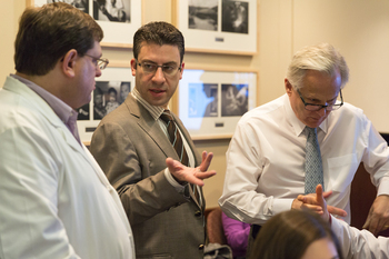 Photo: Eftychios Sifakis, center, talks with Tim King, left, and Court Cutting during a training session for surgical residents.