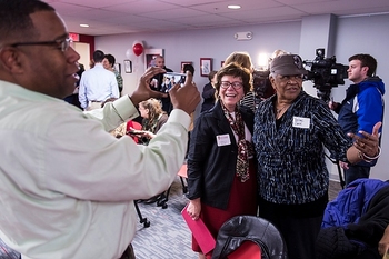 Photo: Rev. Alex Gee, of Fountain of Life Church, makes a photo of UW–Madison Chancellor Rebecca Blank with poet Verline Gee (mother of Alex Gee)