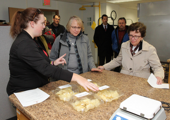 Photo: Research specialist Amber Gotch (left) explains potato chip research to Dean VandenBosch and Chancellor Blank.
